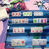 Whimsical Mahjong Tiles Featuring Bold Colored Winds