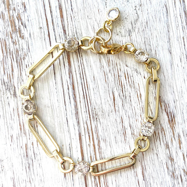 Paperclip gold chain bracelet with cz in between each link.